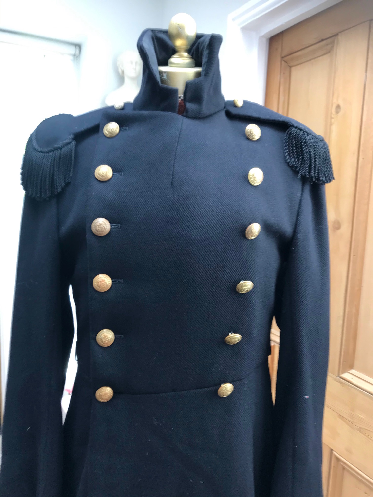 Two black military great coats with epaulettes and buttons. Ex Royal Opera House 'Tosca'